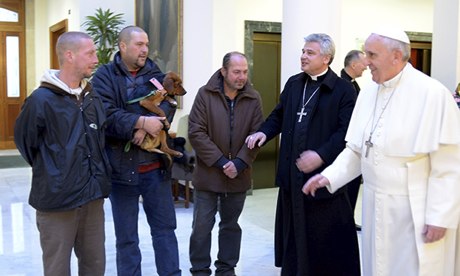 Pope Francis and archbishop Konrad Krajewski welcome some homeless men at the Vatican